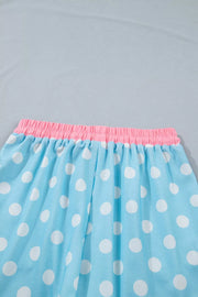 Pastel blue polka dot pajama pants with pink elastic waistband and drawstring detail.