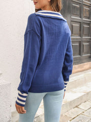 Royal blue knit sweater with white striped collar and cuffs.