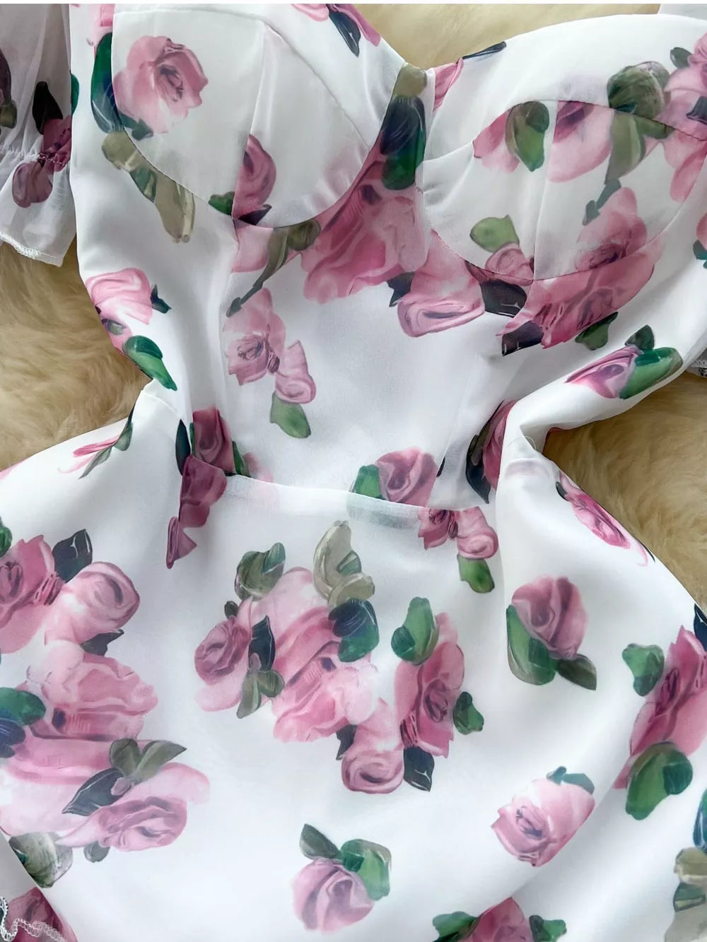 White floral midi dress with pink roses, cotton blend, sweetheart neckline, ruffle hem detail.