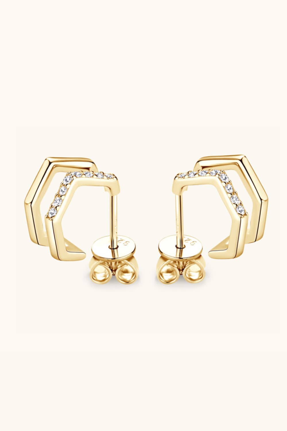 Gold geometric pavé ear jackets with cubic zirconia accents.