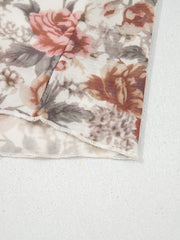 Charming floral mesh blouse with ruffled hem detail.