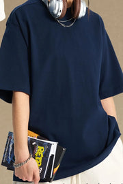 Navy boxy cut t-shirt with short sleeves and a crew neck, styled casually.