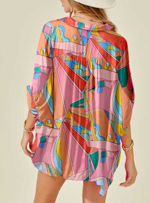 Multicolor psychedelic print batwing blouse with buttoned collar and dolman sleeves.