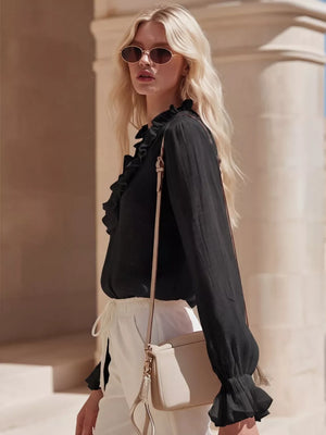Black V-neck maternity shirt with ruffled neckline and cuffs, long sleeves.