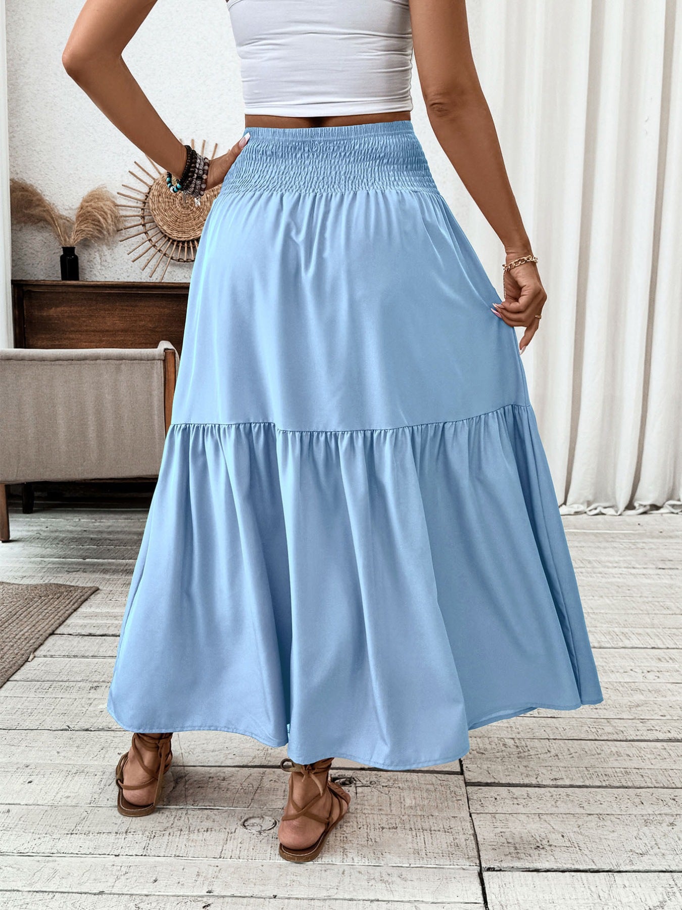 Light blue ruffled smocked waist maxi skirt with tiered hem detail.