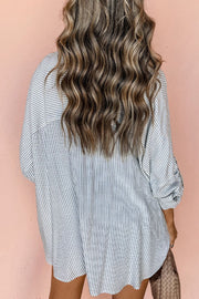 Relaxed fit button-down shirt in white with thin navy stripes and cuffed sleeves.