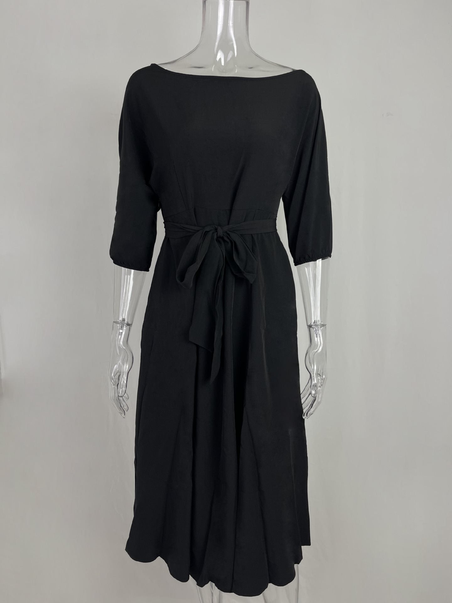 Black belted midi dress with 3/4 sleeves and a tie waist.