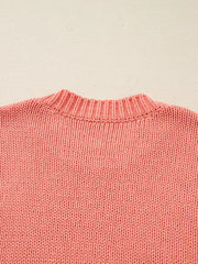 Burnt coral knit sweater with ribbed crewneck and textured stitch detail.