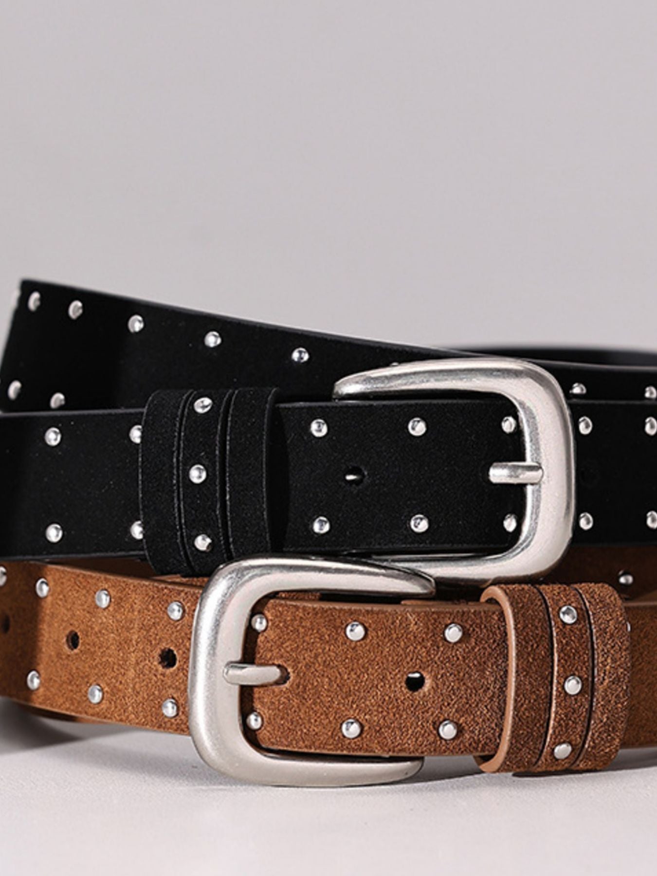 Black and brown studded cowhide leather belts with silver buckles
