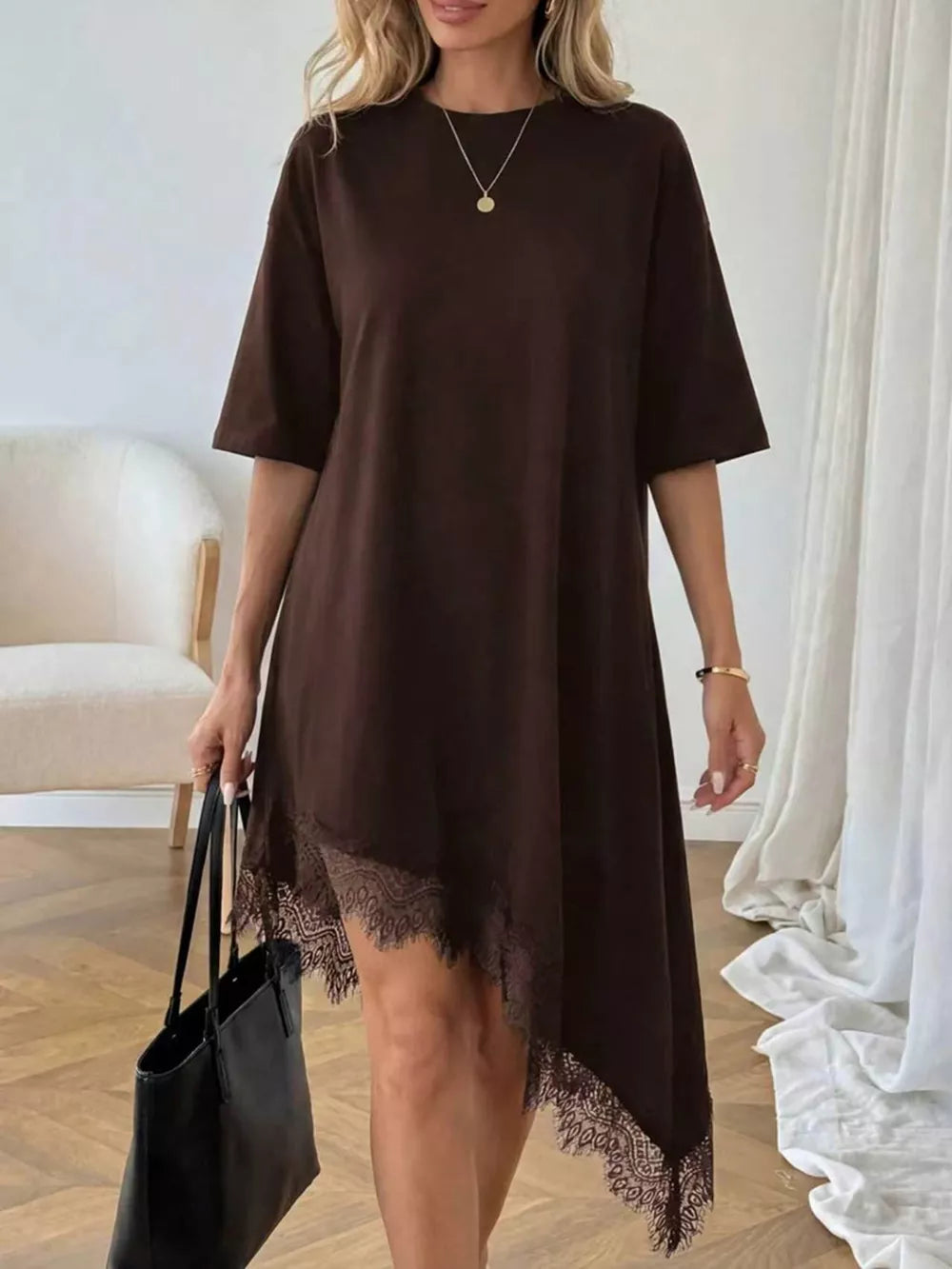 Chocolate asymmetrical t-shirt dress with lace trim hem and short sleeves.