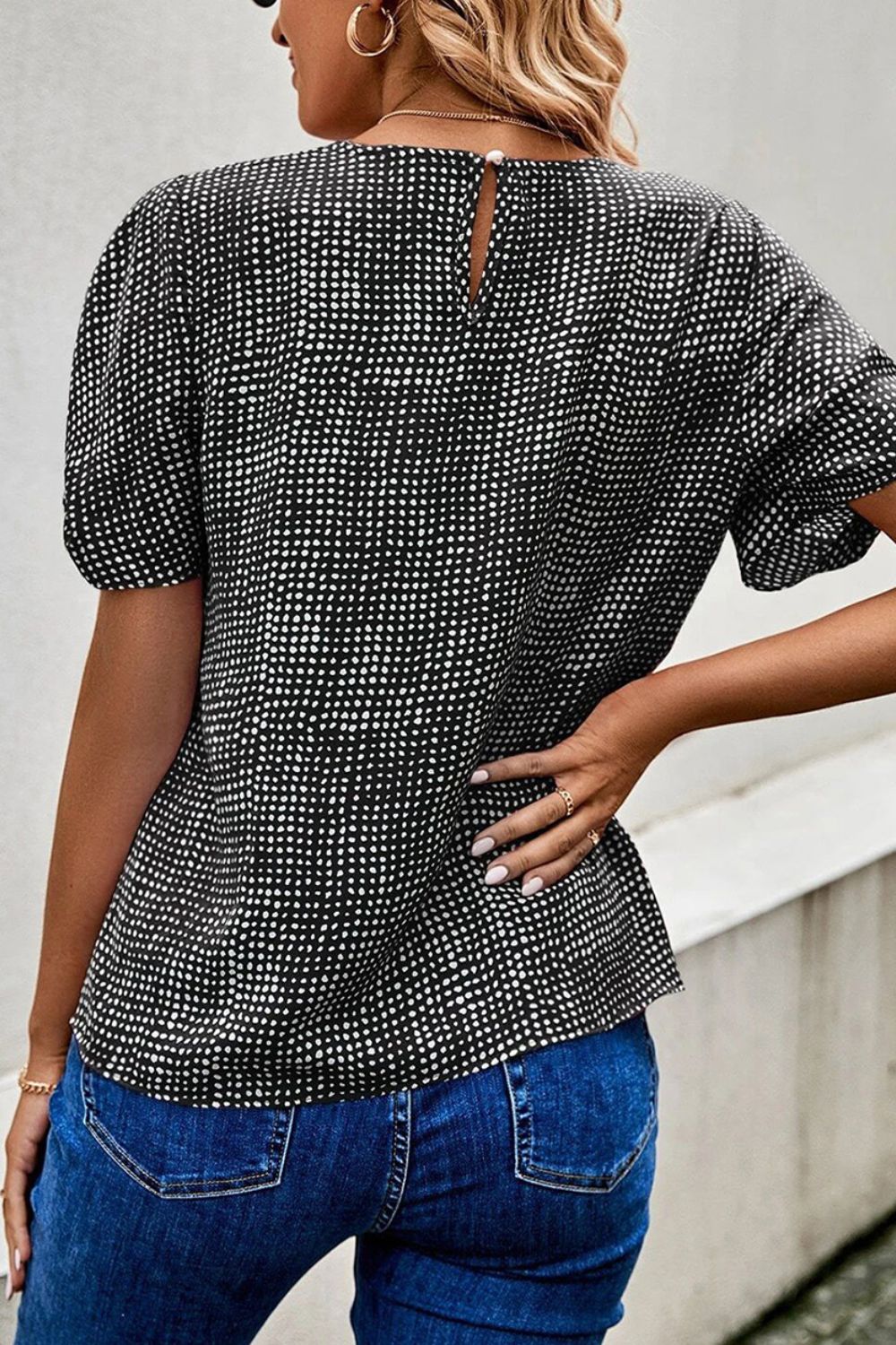 Black dotted puff sleeve blouse with keyhole back detail.