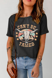 Black graphic tee with bull skull and mountains, "Can't Be Tamed" text