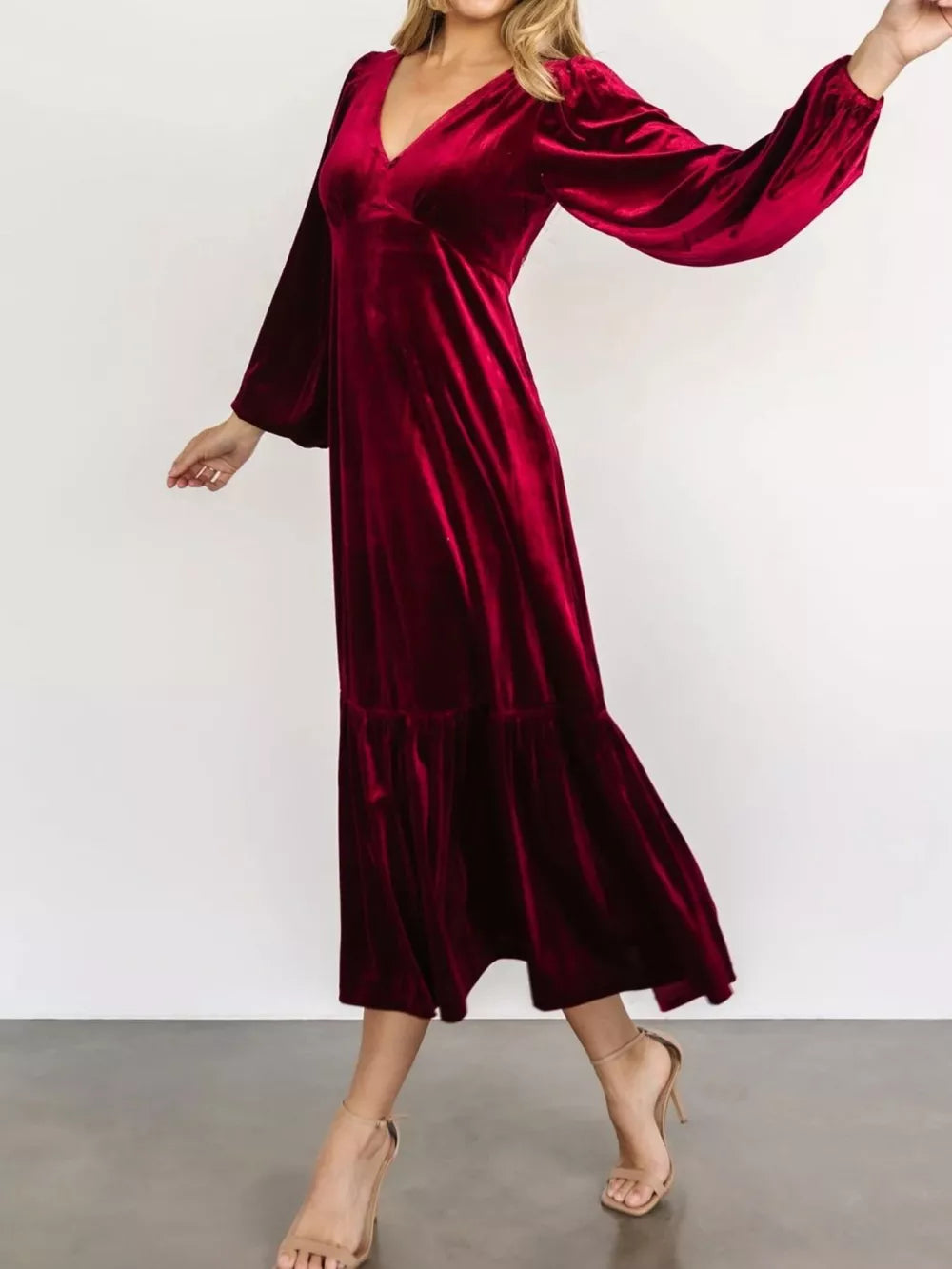 Burgundy velvet midi dress with V-neck, long sleeves, and tiered skirt.