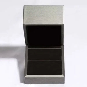 Open gray jewelry box with black interior.