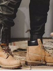 Men's black cargo jogger pants with zippered ankles and elastic cuffs.