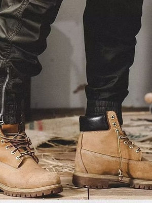 Men's black cargo jogger pants with zippered ankles and elastic cuffs.