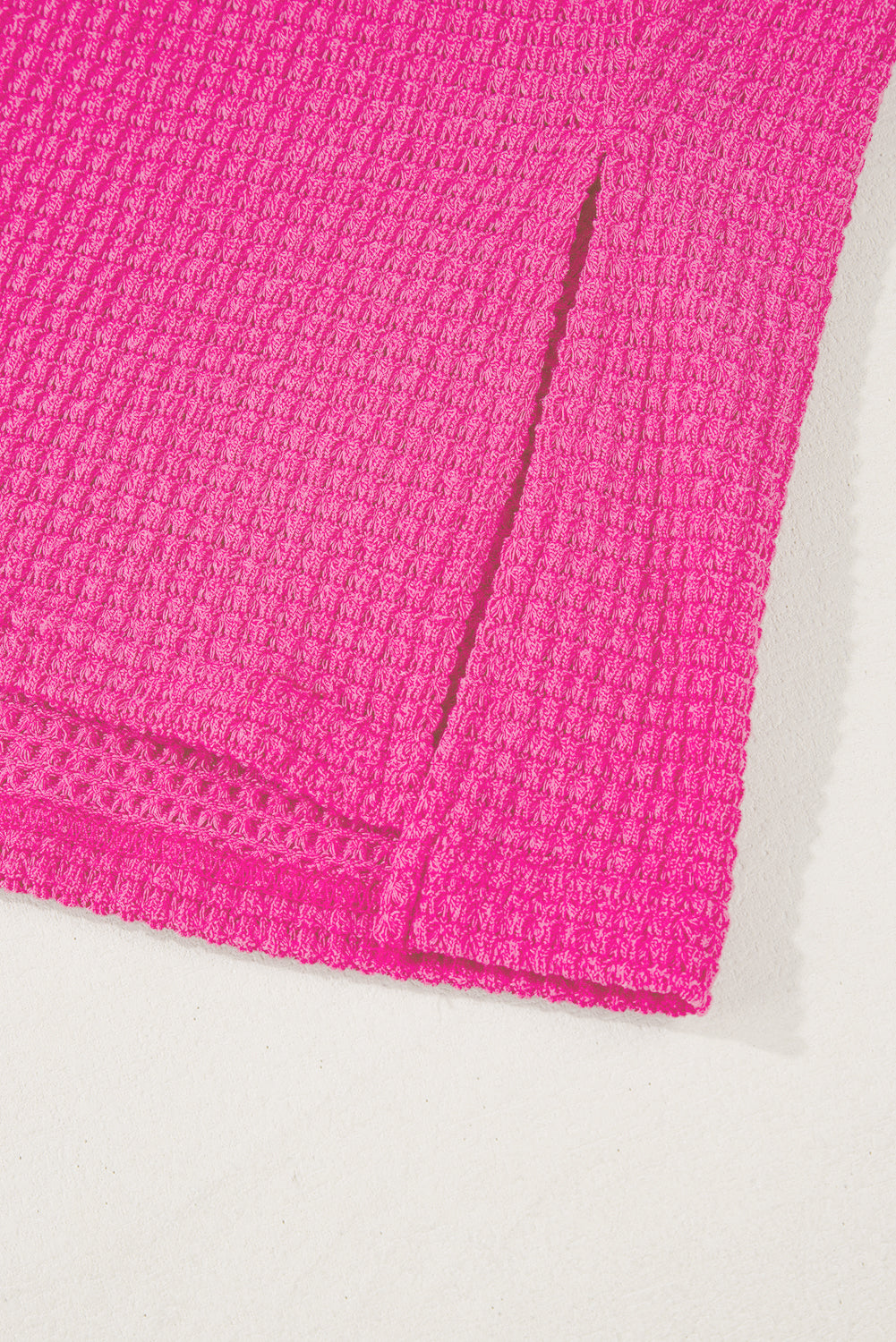 Hot pink waffle knit v-neck top with slit hem detail