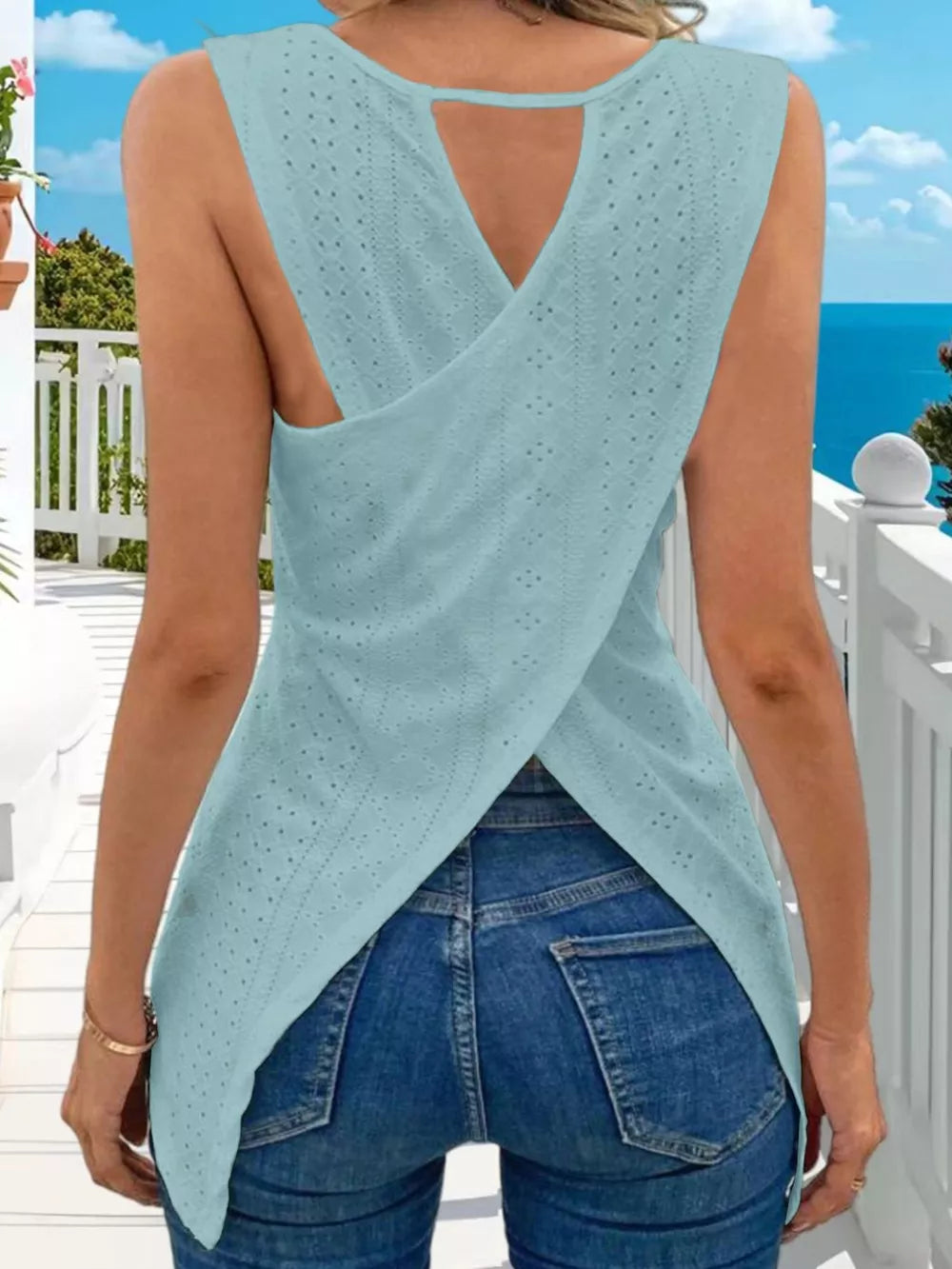 Sky blue openwork knit tank top with crisscross back detail and crew neck.