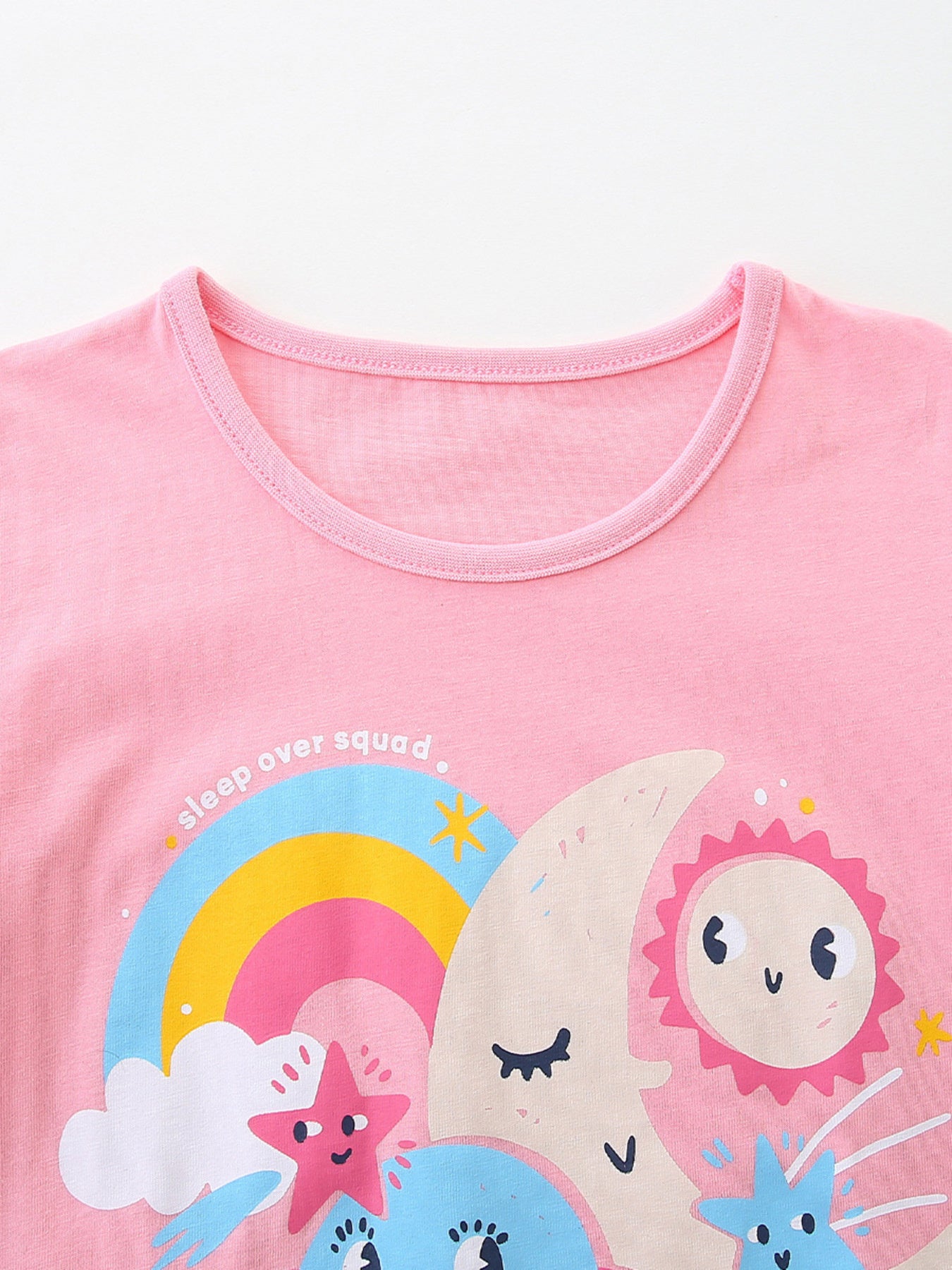 Pink cotton crew neck t-shirt with celestial graphic and "sleep over squad" text.