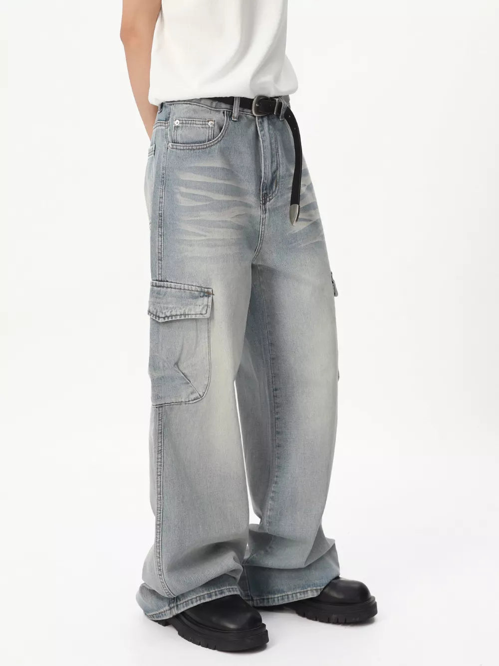Relaxed fit light wash denim cargo jeans with vintage appeal and a black belt.