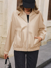 Tan zip up bomber jacket with elastic cuffs and hem, and front pockets.