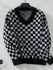 Checkerboard knit v-neck pullover sweater in black and white.