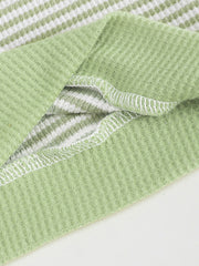 Green and white striped cotton polo shirt with waffle knit texture and white stitching detail.