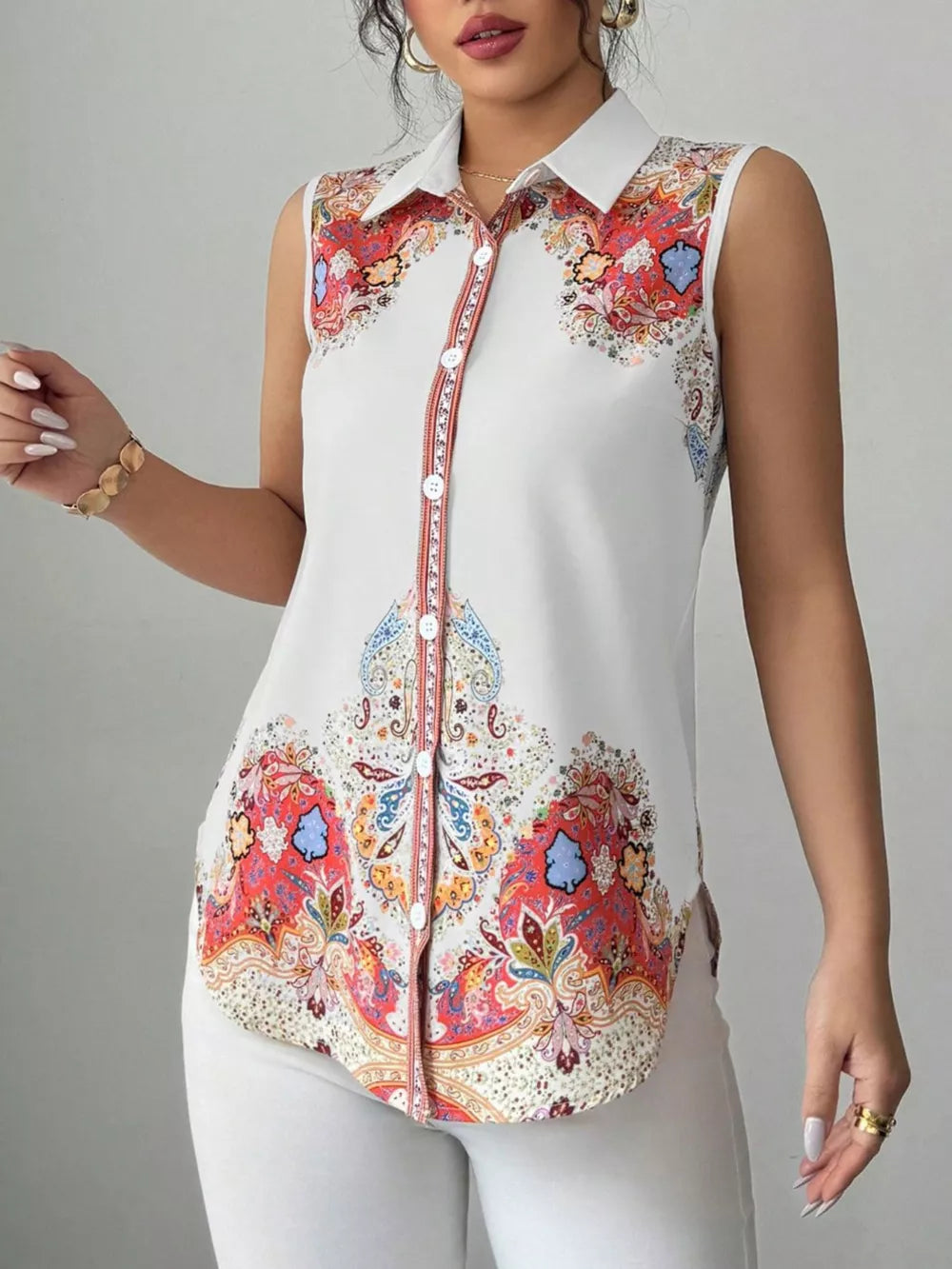 Vibrant paisley collared sleeveless white shirt with button front.