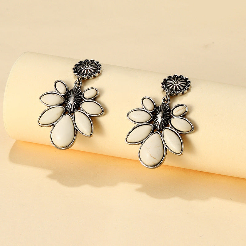 White petal drop earrings with silver-tone alloy floral accents.