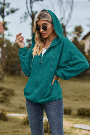 Turquoise textured cable knit zip-up hoodie with drawstring hood and pockets.