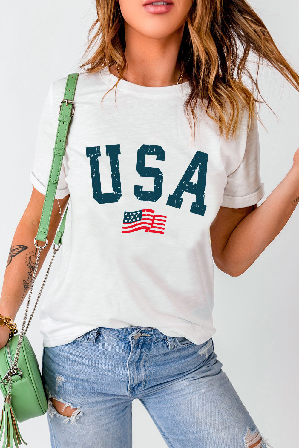 White USA graphic t-shirt with distressed navy lettering and American flag detail.