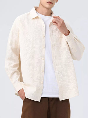 Textured oversized button-up shirt in off-white with a classic collar and button closure.