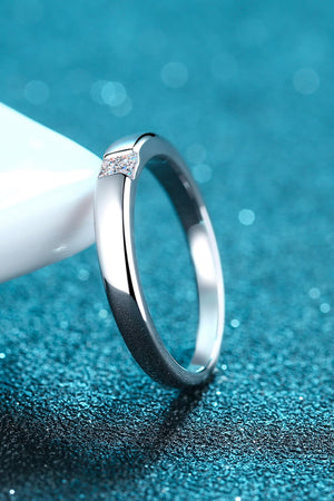 Silver band ring with a single prism-cut solitaire stone detail.