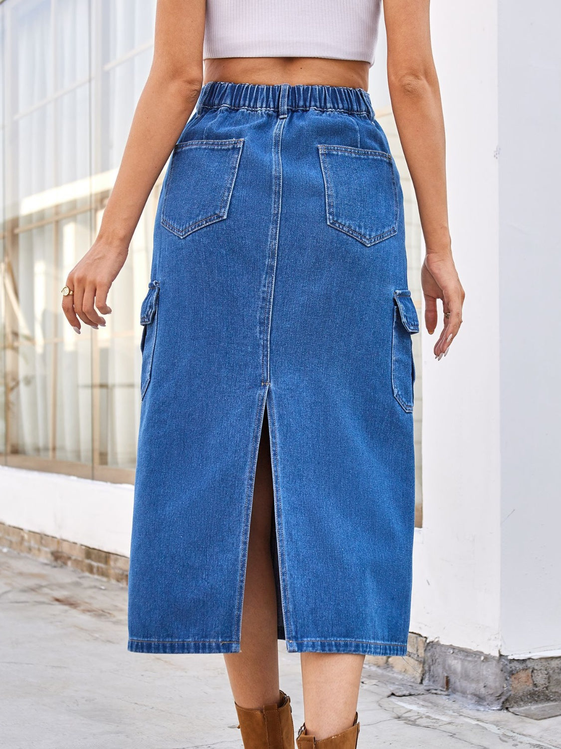 Medium wash denim midi skirt with cargo pockets and front slit