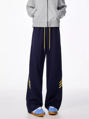 Dark navy sweatpants with yellow stripe detail and yellow drawstring.