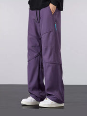 Men's purple loose fit cargo pants with drawstring and zippered pockets.