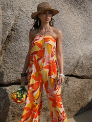 Strapless floral print jumpsuit in tangerine with wide legs and a tie back detail.