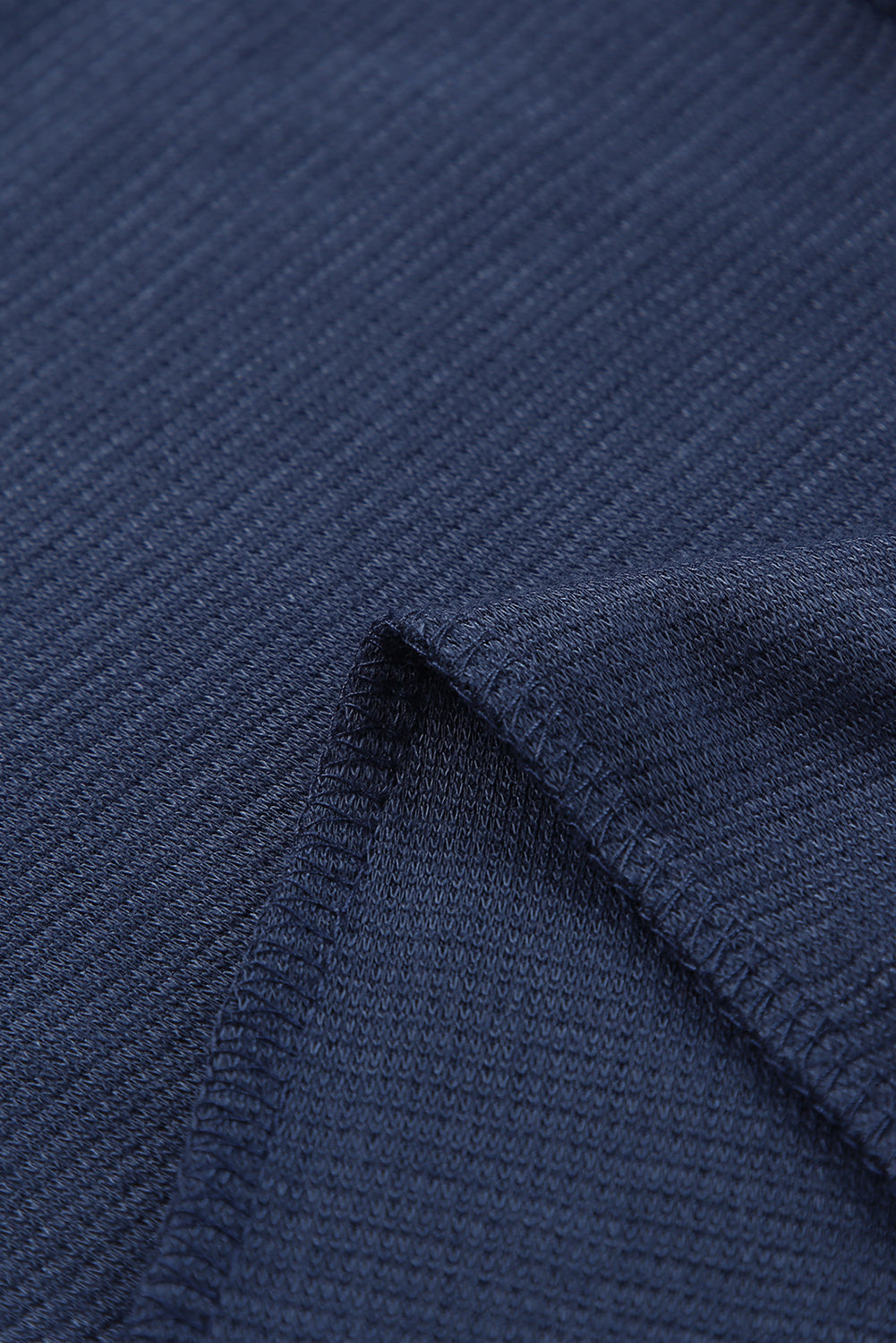 Navy jersey jumpsuit fabric detail with visible stitching