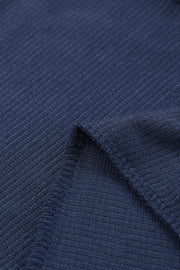 Navy jersey jumpsuit fabric detail with visible stitching