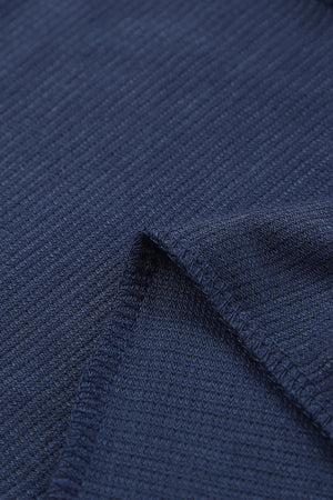 Navy jersey jumpsuit fabric detail with visible stitching