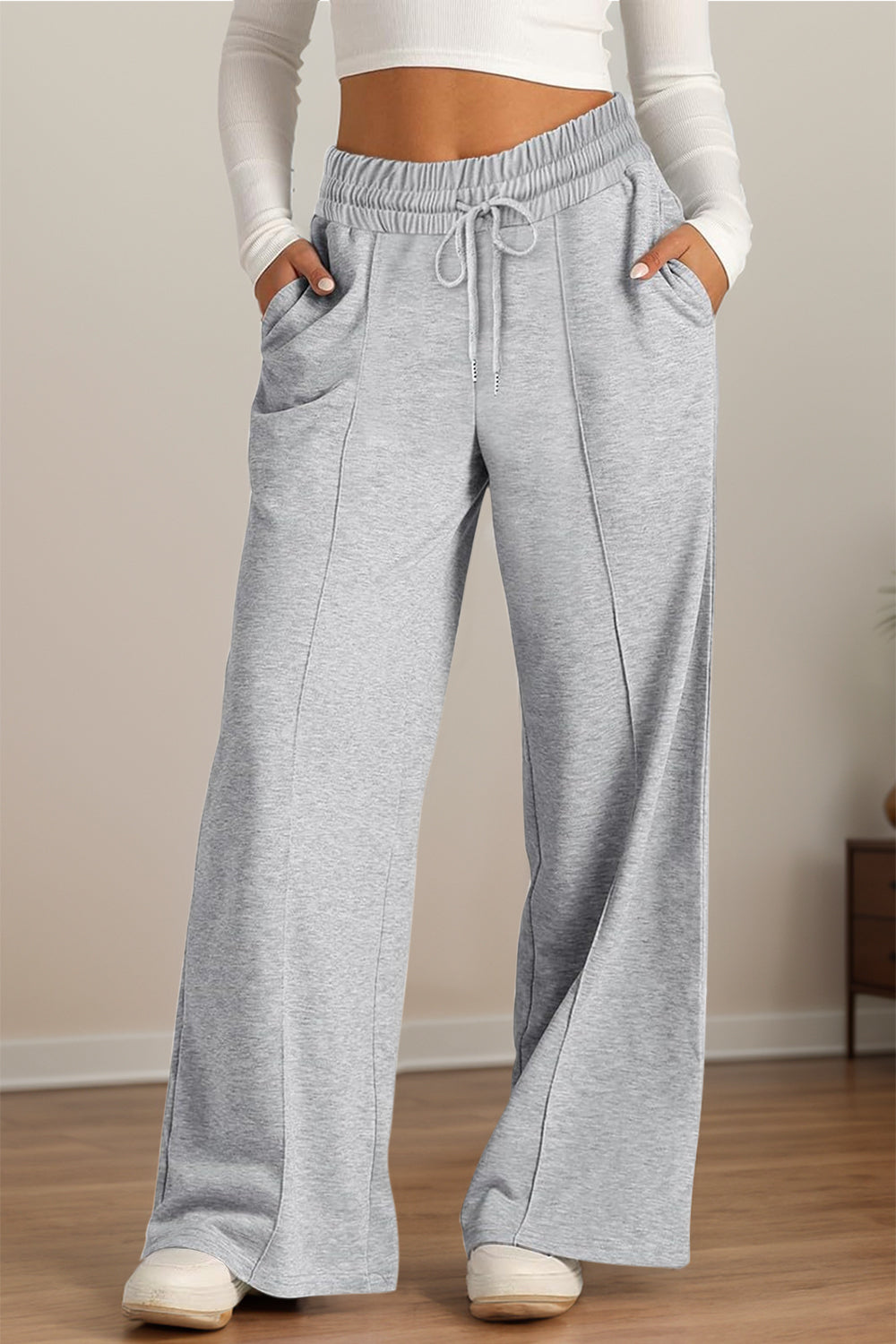 Gray seamed palazzo lounge trousers with drawstring waist and pockets.
