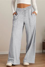 Gray seamed palazzo lounge trousers with drawstring waist and pockets.