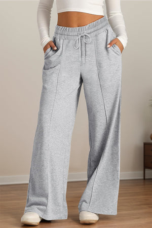 Gray seamed palazzo lounge trousers with drawstring waist and pockets.