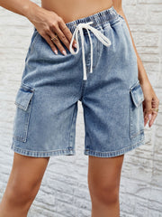 Denim cargo shorts in dusty blue with drawstring waist and side pockets.