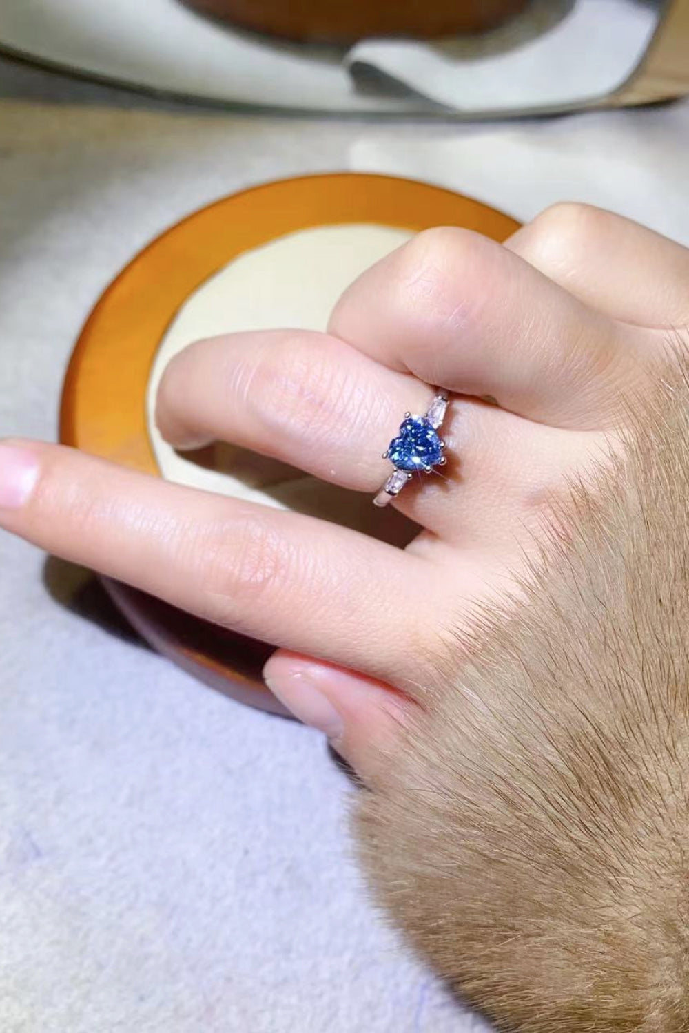 Blue heart sapphire trilogy ring in sterling silver with accent stones