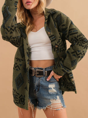 Green sherpa overshirt jacket with bold Aztec pattern and button front, styled with denim shorts.