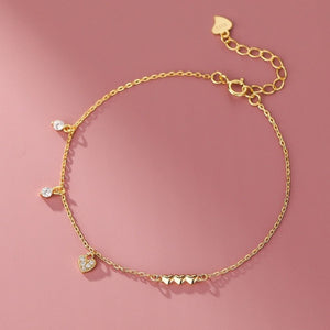 Gold pavé heart charm bracelet with cubic zirconia accents and a delicate chain.
