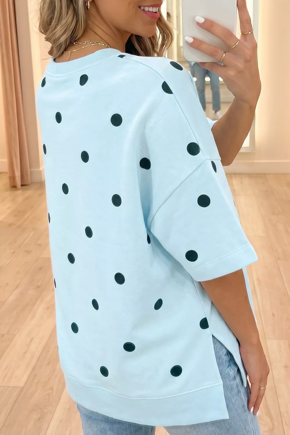 Light blue oversized t-shirt with black polka dots and short sleeves.