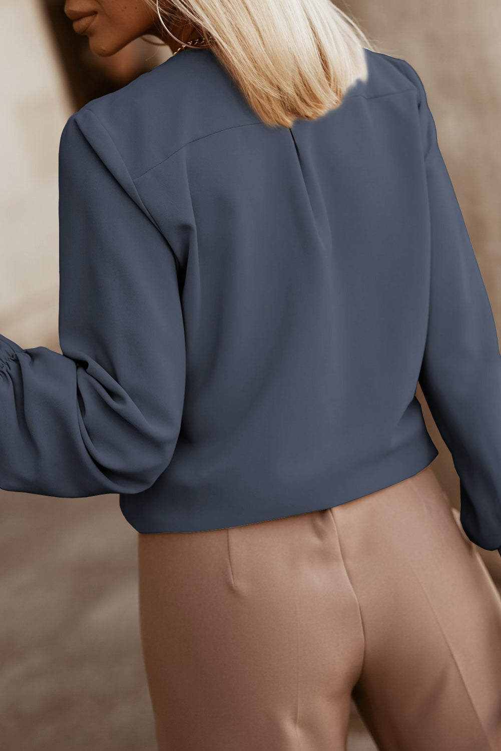 Misty Blue pleated yoke blouse with button detail and gathered sleeves.