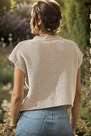 Textured knit top in khaki with short sleeves and a mock neck, styled with denim jeans.